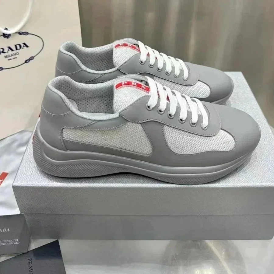 Grey Re-Nylon runner-style sneakers displayed on a shoebox