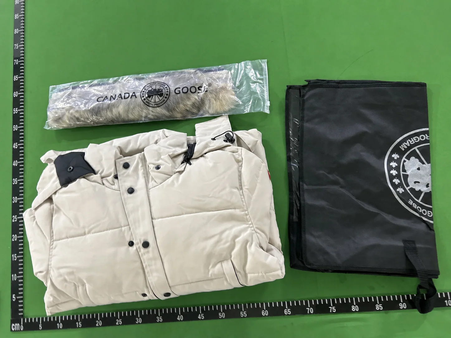 QC photo showing the folded parka, removable fur trim and storage bag